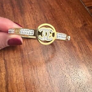 Gold tone stainless steel with Silver Crystal accents Bangle